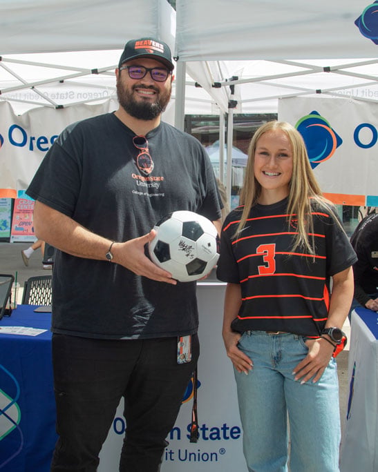 Dam Proud Day 2026 OSU Women's Soccer Player Abby Smith posting with fan holding signed soccer ball