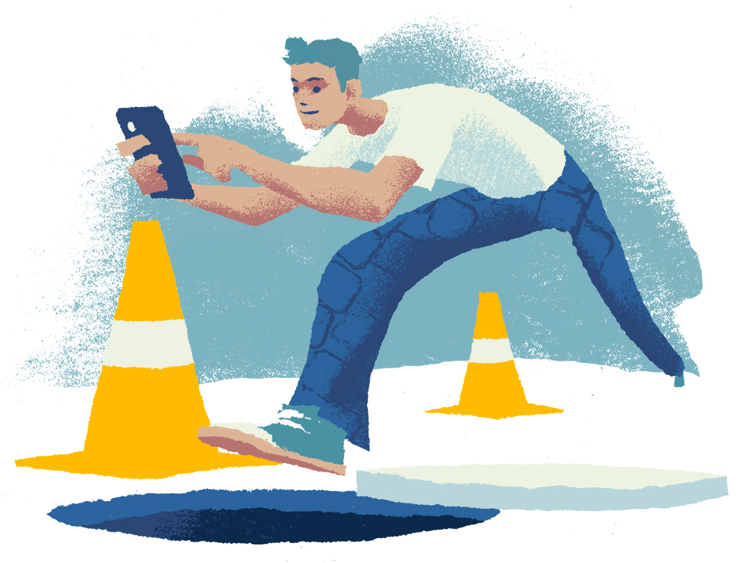 A man nearly falls into an open manhole while looking at his phone.