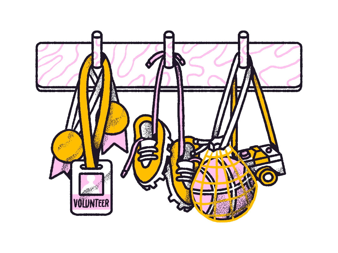 School bags and a badge hanging on hooks.