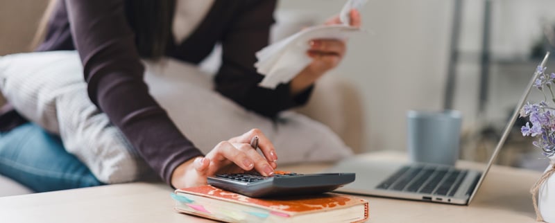 woman crunching numbers on a calculator