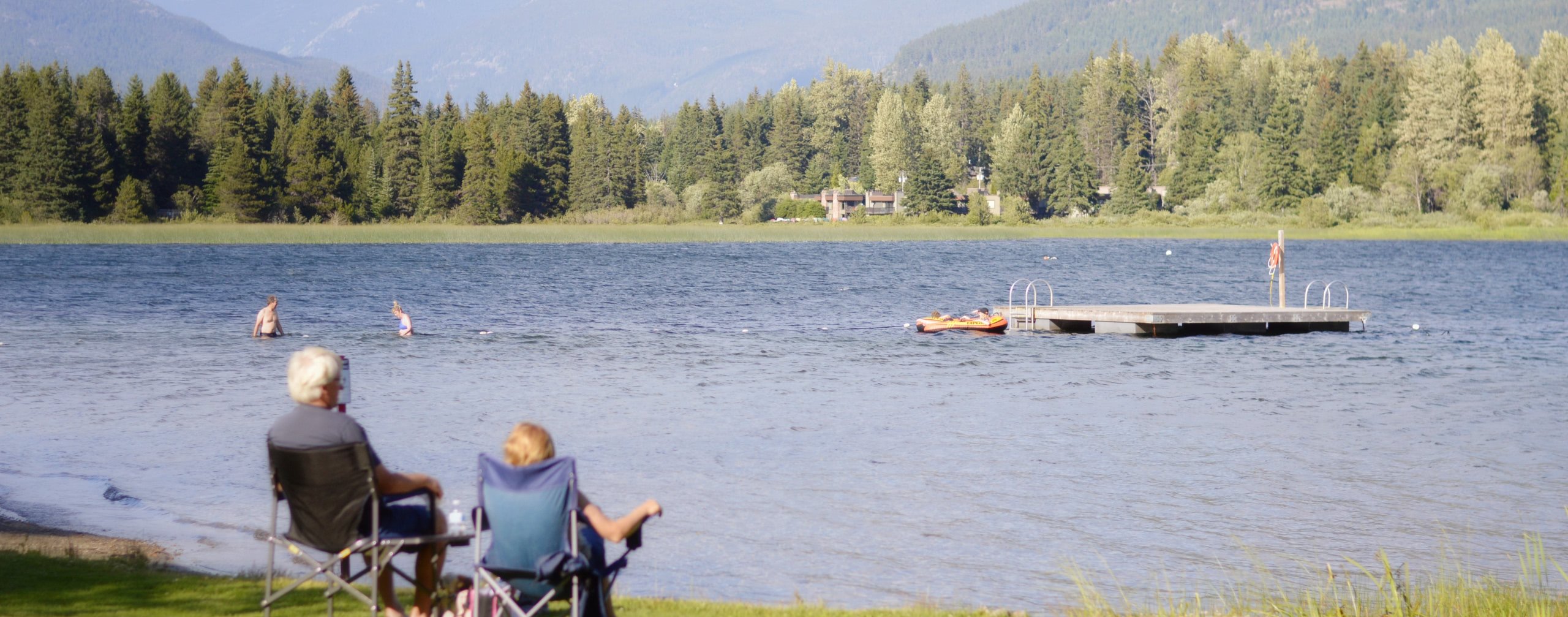 retired couple sitting by lake